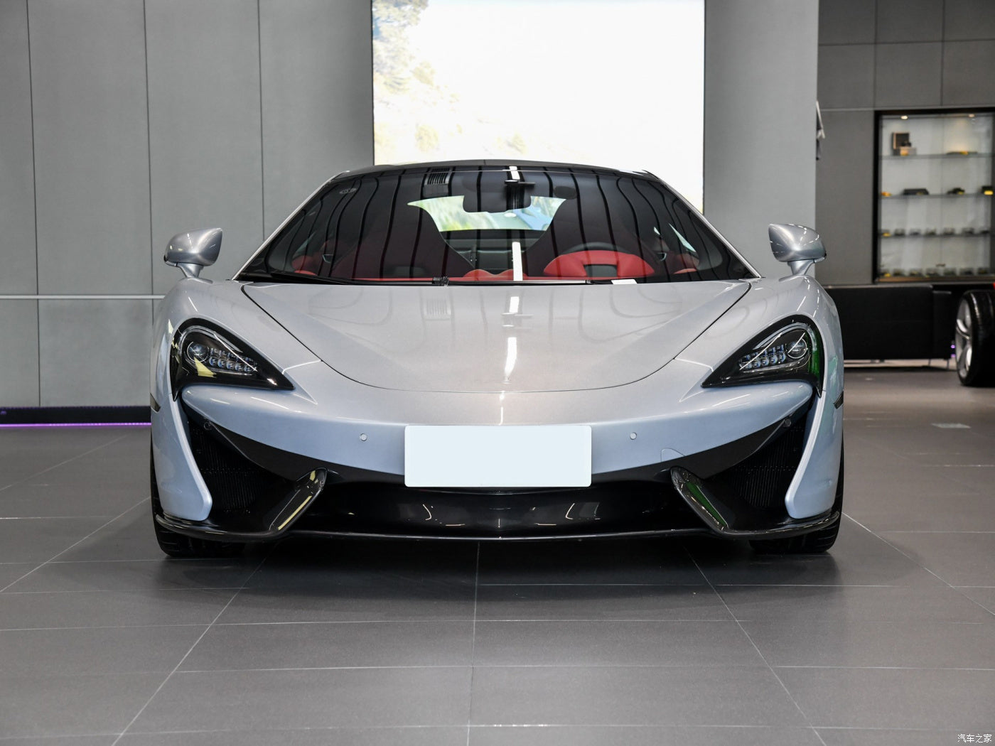 White sports car in a showroom setting